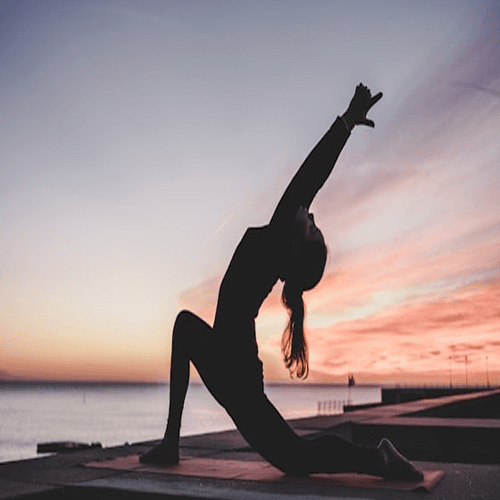 Group of diverse people practicing yoga outdoors